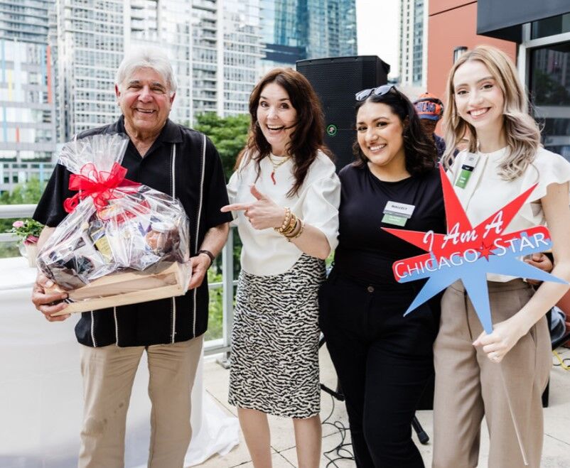 Amanda Puck, VP Mariano's/Roundy's Communications Brand Development, Mariano's Nallely Silva and Lucy Gutierrez present raffle winner Lou Rago with a basket of Mariano's goodies. (Juan Alvarez photo)